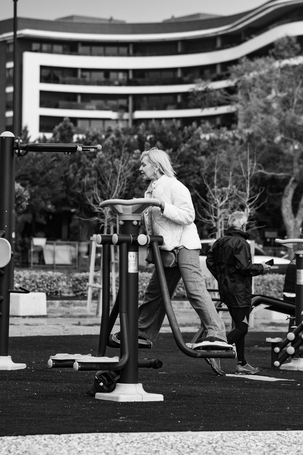 Senior adults exercising on outdoor gym equipment